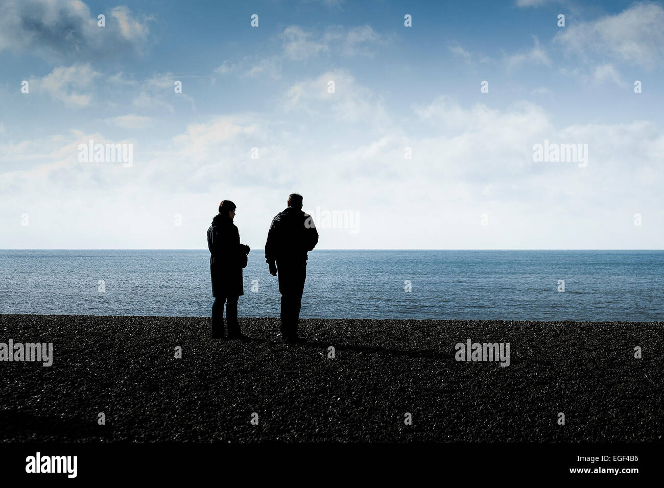 Die Silhouette von ein paar stehen am Strand von Brighton. Stockfoto