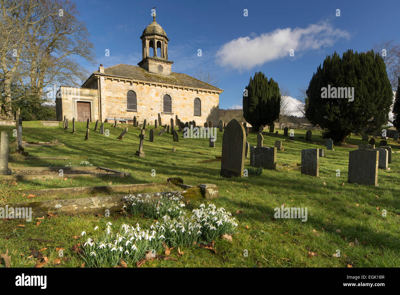 All Saints Church und Schneeglöckchen am Brandsby in North Yorkshire. Stockfoto
