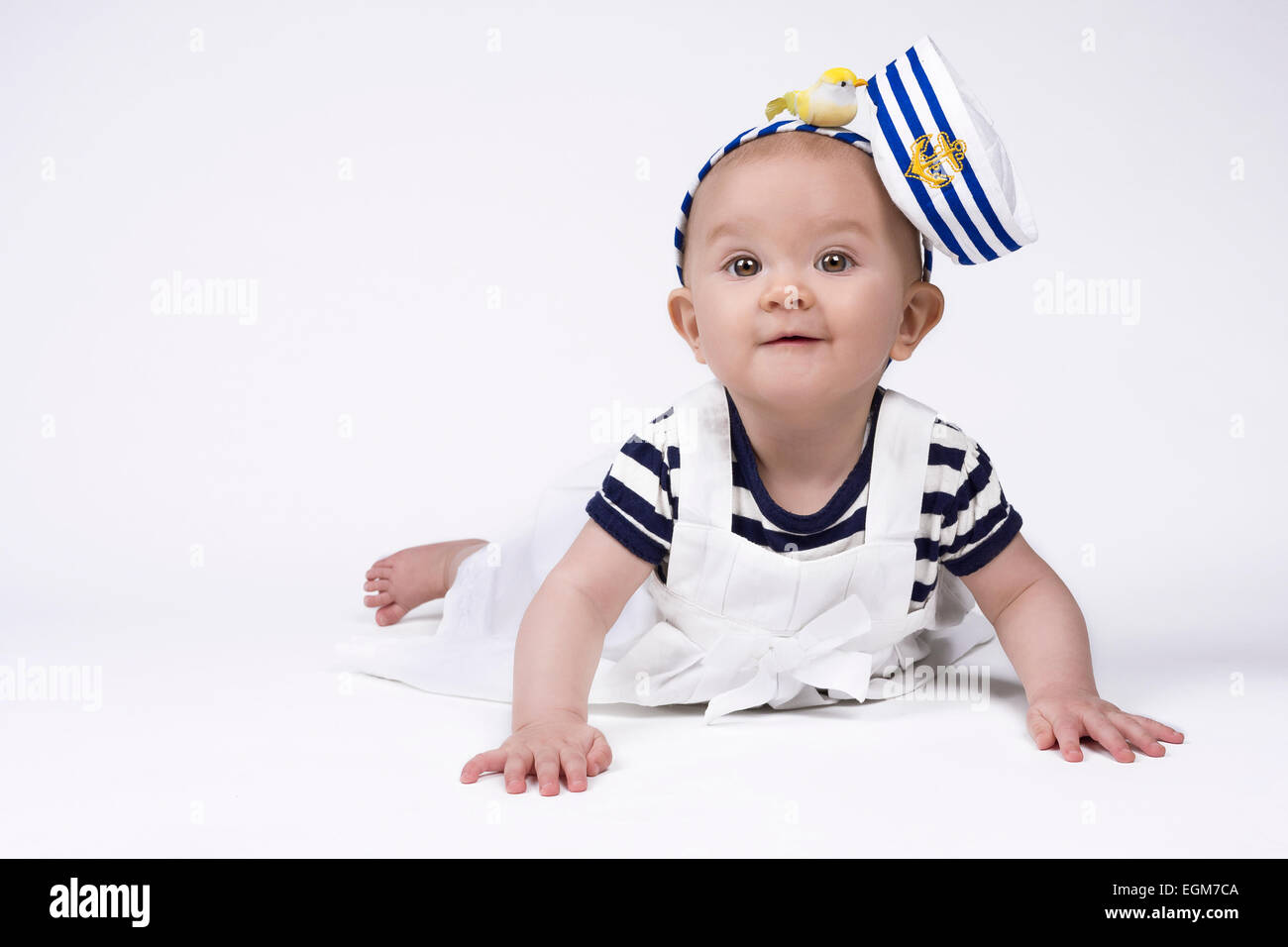 schöne Babymädchen trägt ein Seemann-Outfit und lächelnd Stockfoto