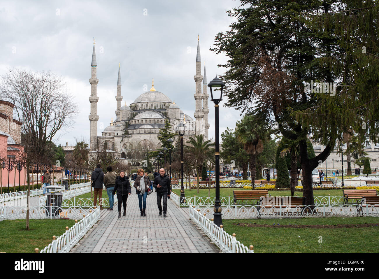 Sultanahmet-Platz Touristen Istanbul Türkei // ISTANBUL, Türkei - Touristen spazieren durch den Sultanahmet-Platz, den historischen platz zwischen der Sultan-Ahmed-Moschee (Blaue Moschee) und der Hagia Sophia. Dieser Raum dient als Herz von Istanbuls historischem Viertel und verbindet zwei der bedeutendsten religiösen Denkmäler der Stadt. Der Platz ist der zentrale Punkt von Istanbuls UNESCO-Weltkulturerbe. Stockfoto