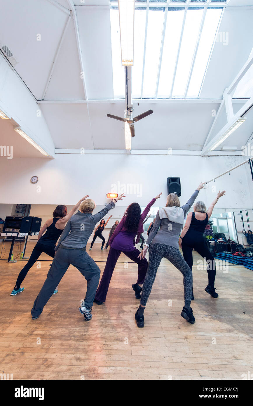 ältere Damen / Frauen, genießen eine Fitness-Salsa-Tanz-Gruppe Übung zur Vorlesung in einem hellen und luftigen Fitnessstudio Stockfoto