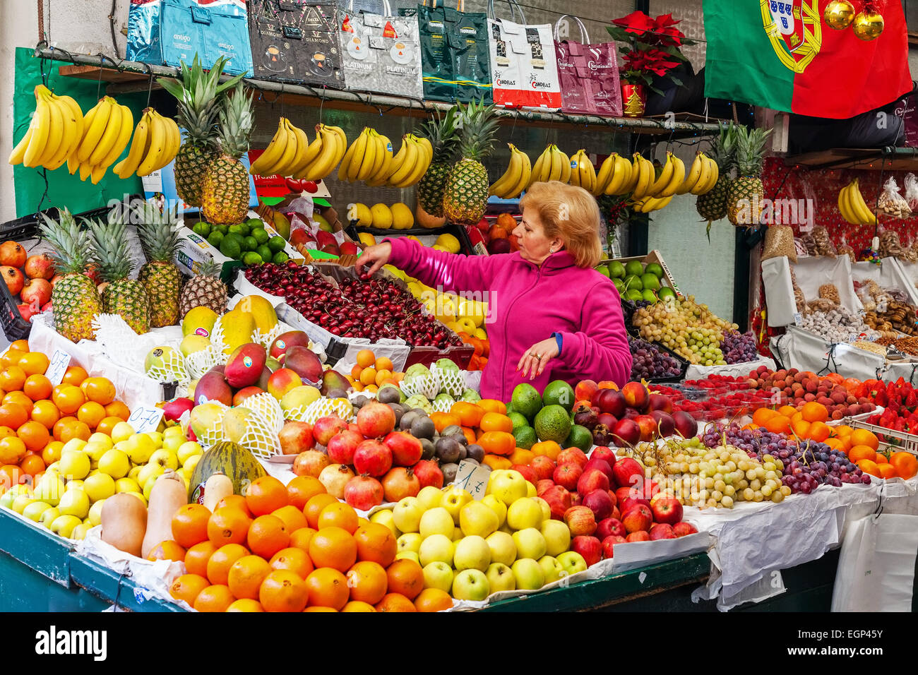 Porto, Portugal. Obst-Verkäufer organisiert und kümmert sich um den Stand in das Innere des historischen Bolhao Markt Stockfoto