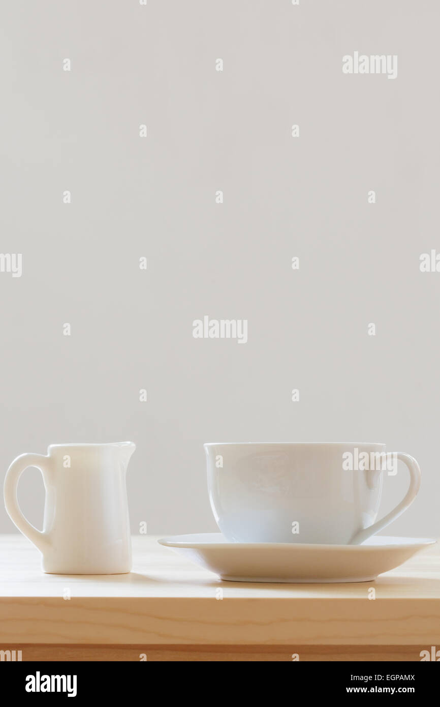 Kaffee und Milch auf Holztisch mit weißem Hintergrund Stockfoto