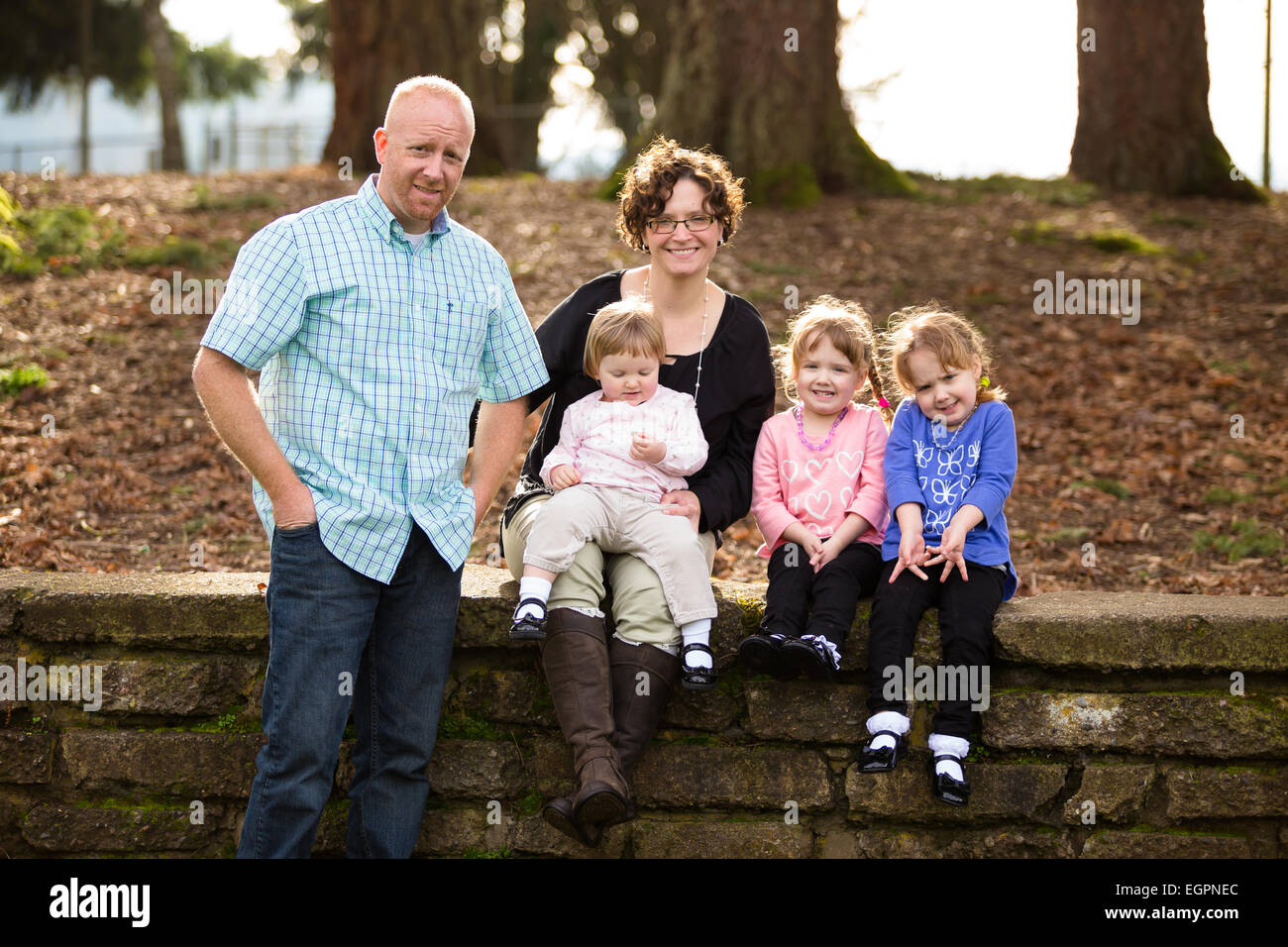 Lifestyle-Foto für eine fünfköpfige Familie mit Mutter, Vater und drei Töchter. Zwei Töchter sind eineiige Zwillinge. Stockfoto