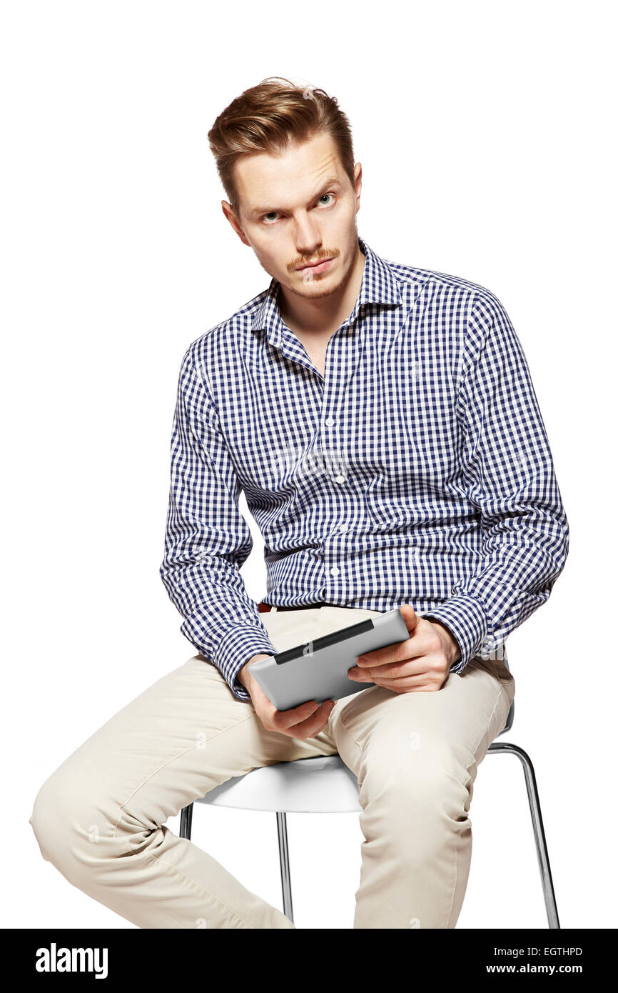 Porträt des jungen nachdenklicher Mann hält eine Tablette. Stockfoto