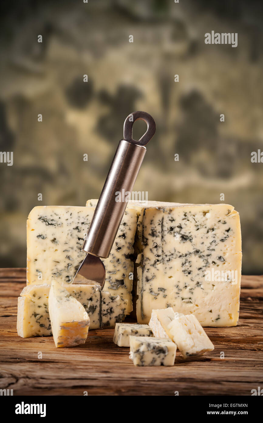 Stillleben mit Blauschimmelkäse serviert auf Holz im Keller Stockfoto