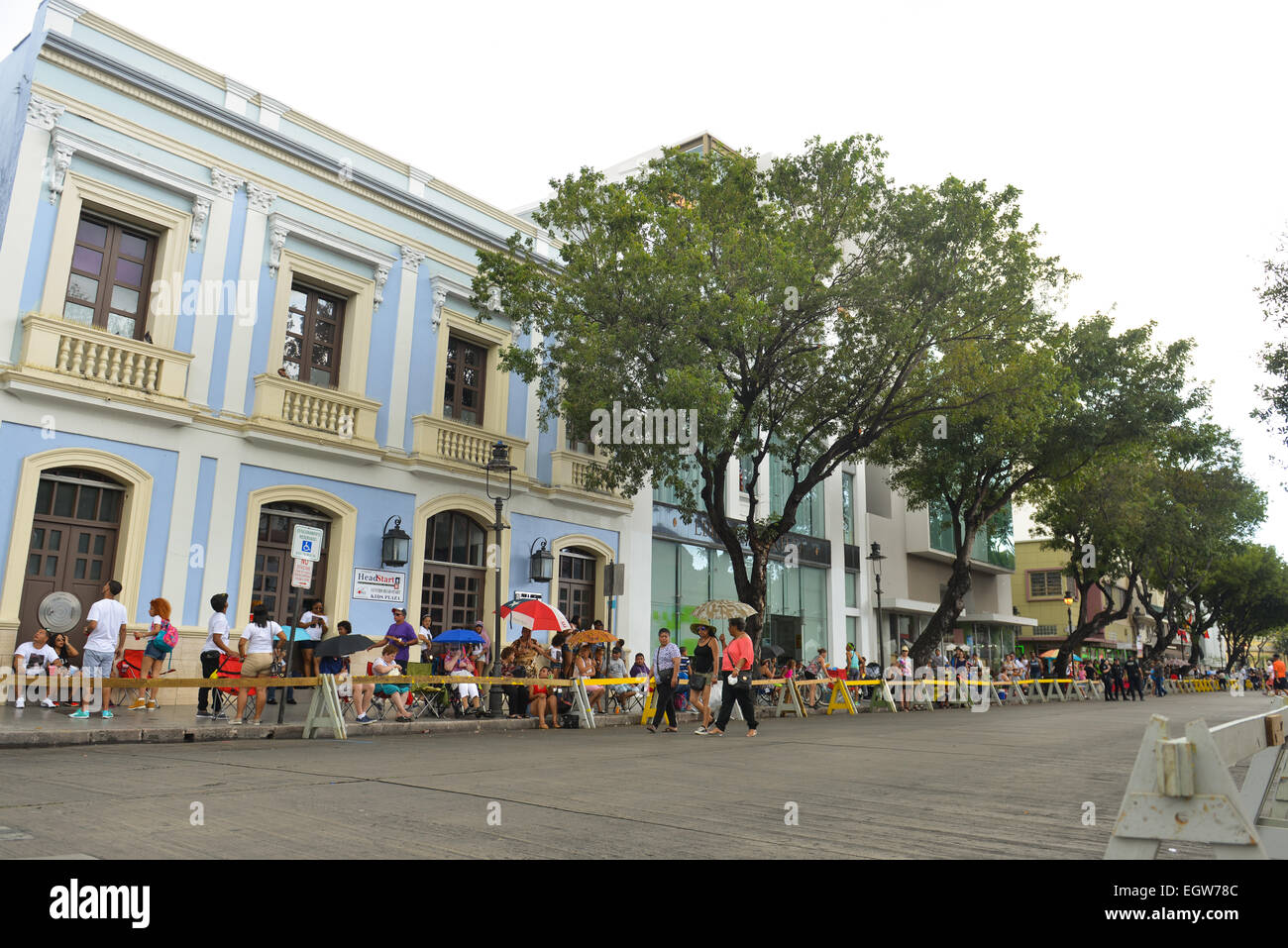 Öffentlichkeit und Touristen nach dem Regen warten auf den Karnevalsumzug in Ponce, Puerto Rico beginnen. Stockfoto