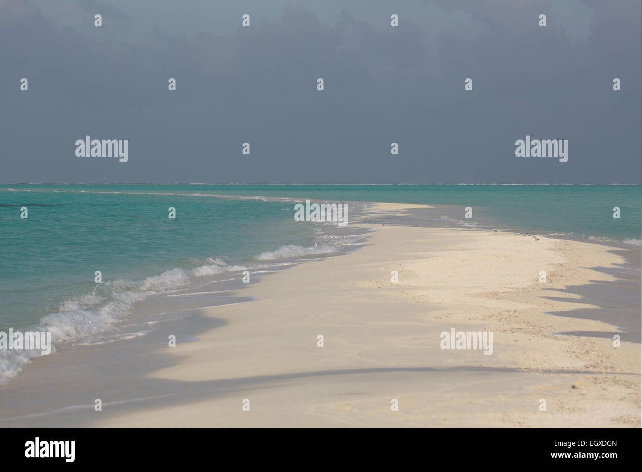 Eine sandigen Landzunge grenzt beidseitig am türkisblauen Meer auf einer Insel auf den Malediven Stockfoto