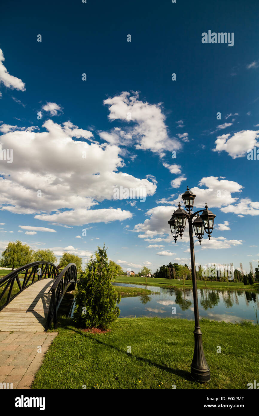 Kleine Brücke über ein Teich und landen auf einer kleinen Rasen Insel Stockfoto