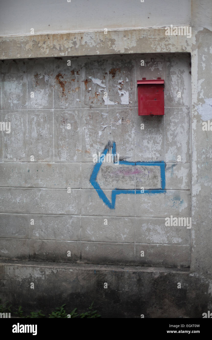 Äußere Brise Blockwand in einem schlechten Zustand mit einem roten  Briefkasten und blauen Punkt links Pfeil, Talat Phlu, Bangkok, Thailand  Stockfotografie - Alamy