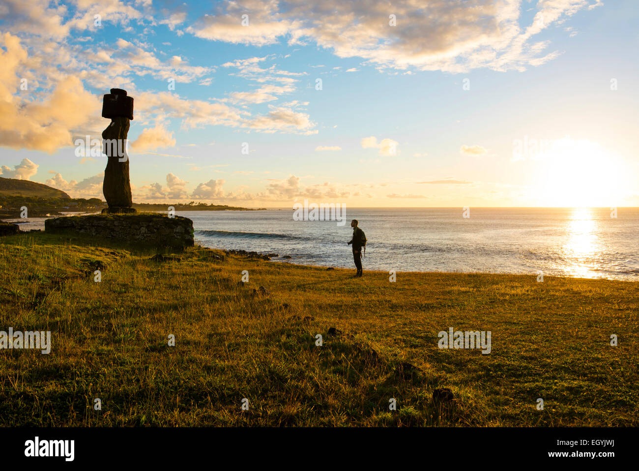 Hanga Roa, Osterinsel, Traveller und Moai Stein Figur im Tahai zeremonielle Complex am Sonnenuntergang, archäologischer Standort Stockfoto