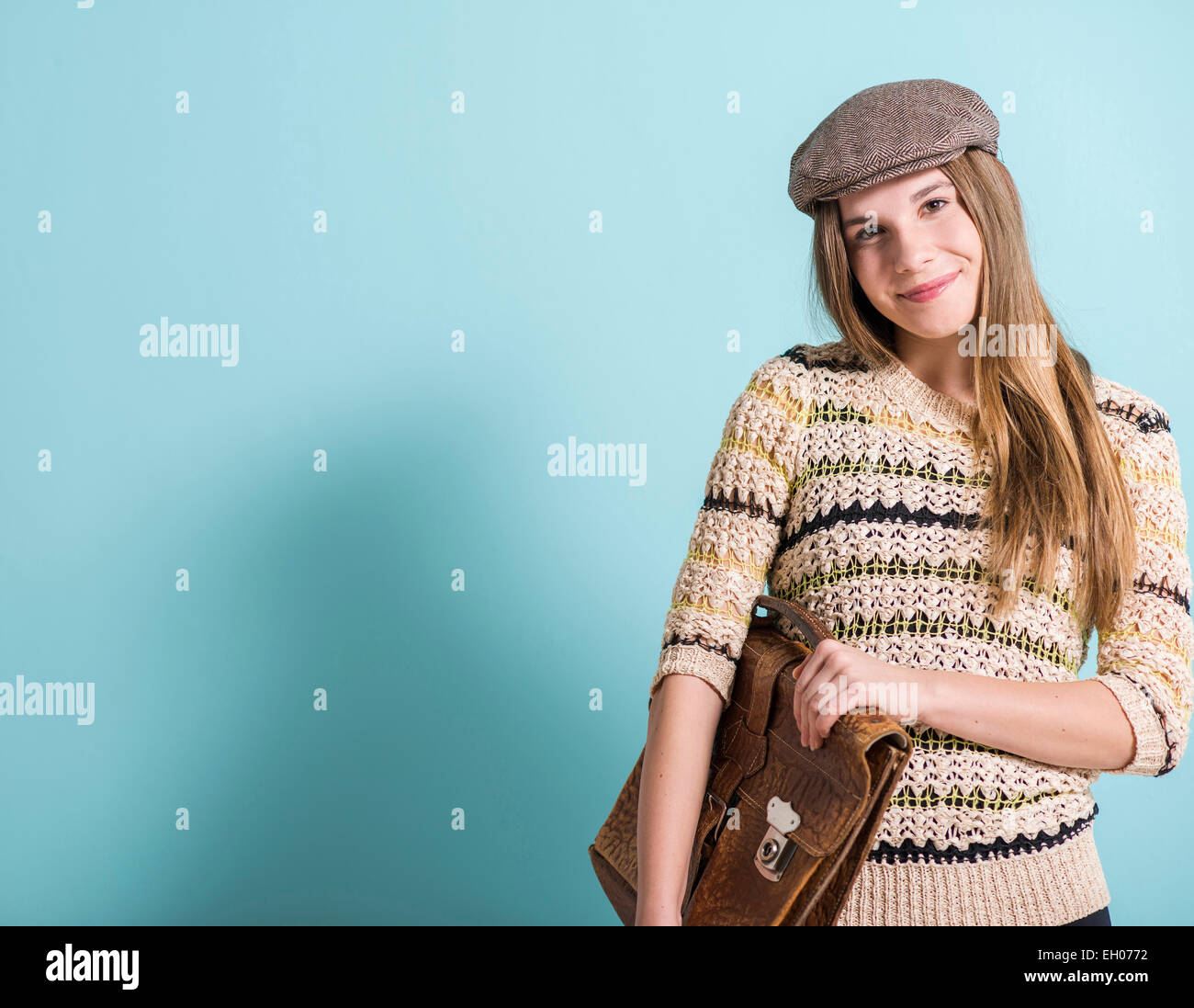 Lächelnde weibliche Teenager mit alten Leder-Aktentasche Stockfoto