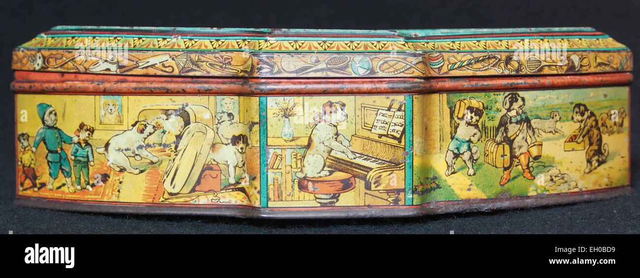 Diese Dose zeigt eine Illustration von Hunden und Katzen, die Tauziehen spielen. Es handelt sich um ein Sammlerstück, das typischerweise mit Vintage-Verpackungen und Tiermotiven assoziiert wird. Stockfoto