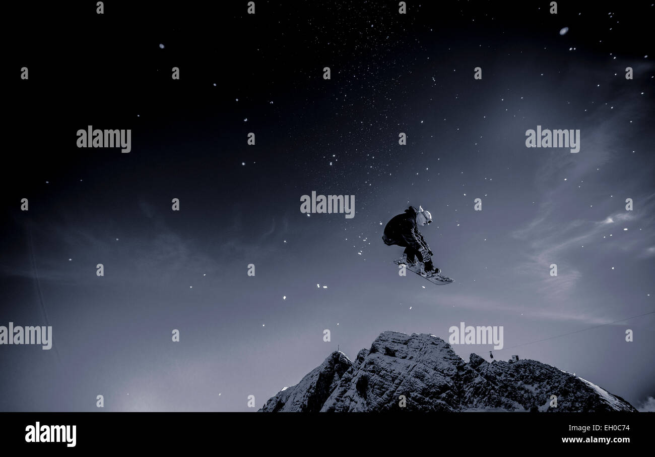 Ein Snowboarder springt in die Luft auf dem Dachstein-Gletscher in Österreich. Stockfoto