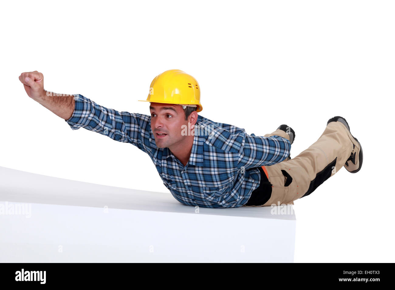 Arbeiter in Superman-pose Stockfoto