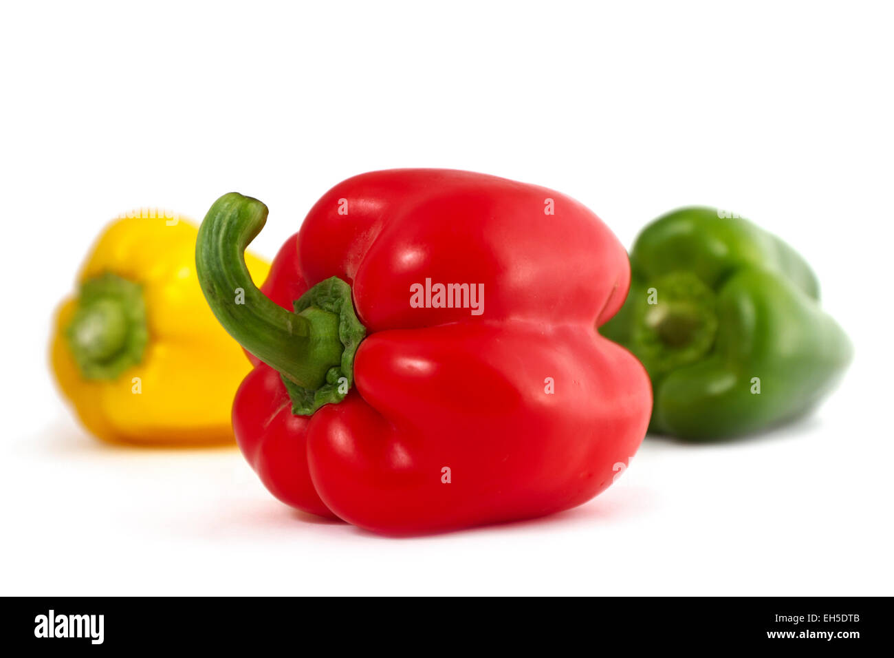 Bio und frische rote, grüne und gelbe Paprika auf weißem Hintergrund. Stockfoto