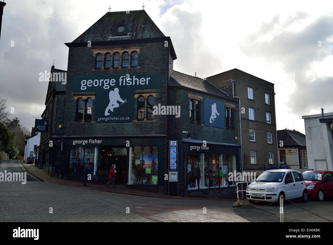 George Fischer Outdoorladen in Keswick Cumbria uk mit der Sonne hinter Winter Wolken Stockfoto