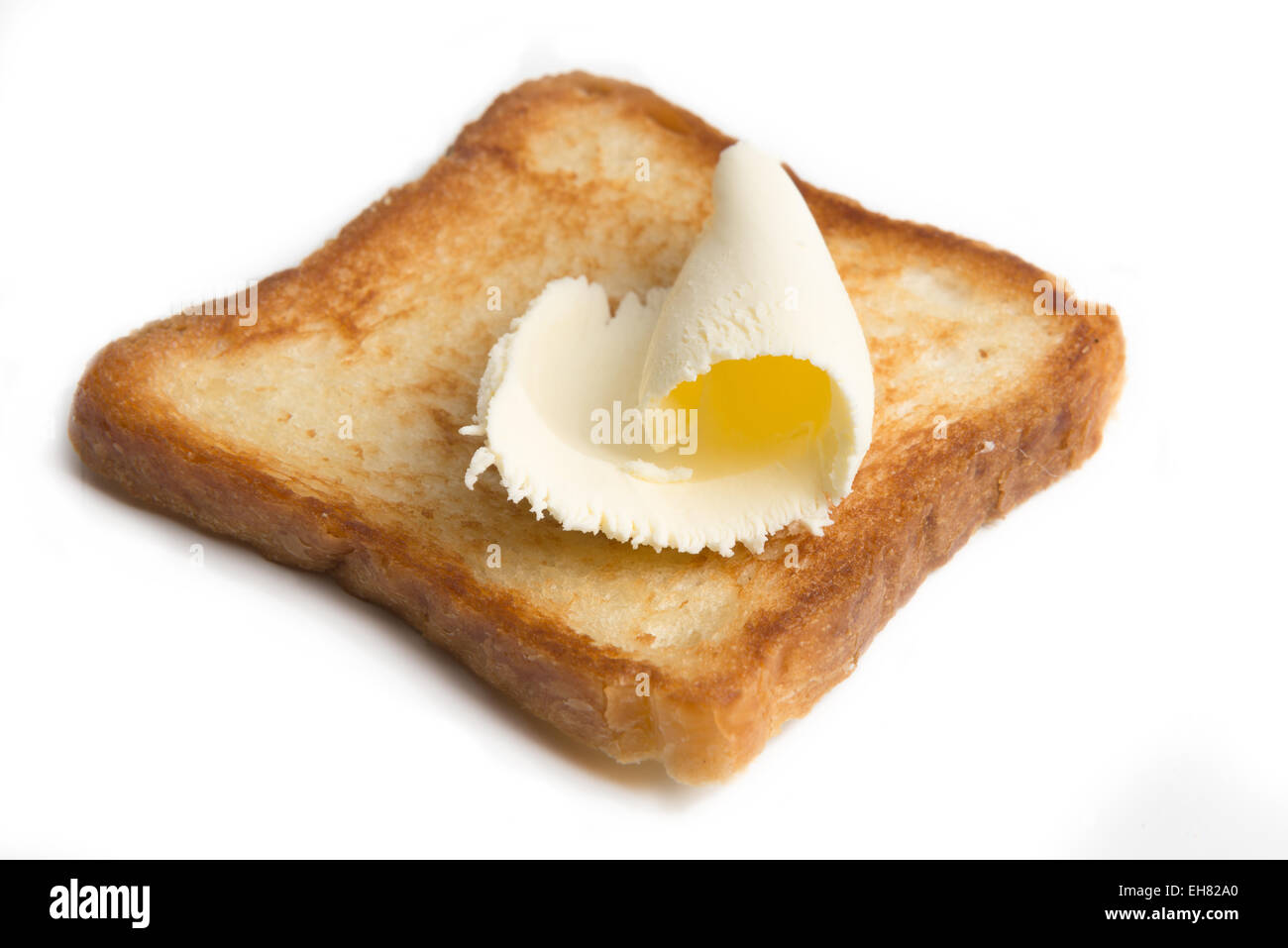 Butter auf einer Scheibe Toastbrot isoliert Stockfoto
