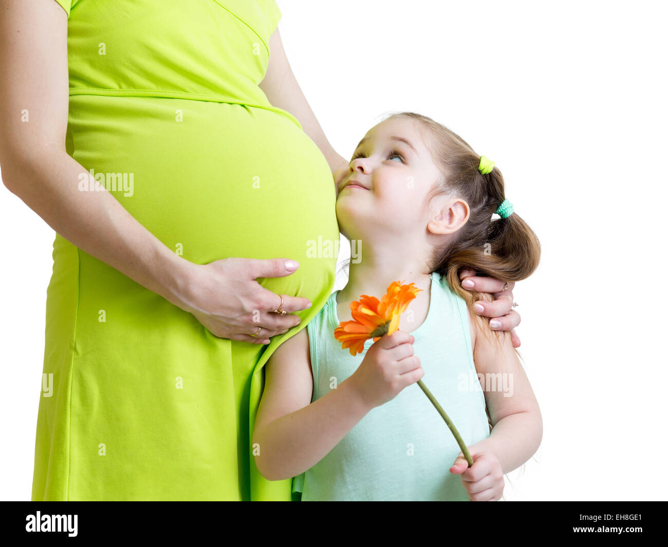 glückliches Kind, die Blume sieht schwangere Mutter Stockfoto