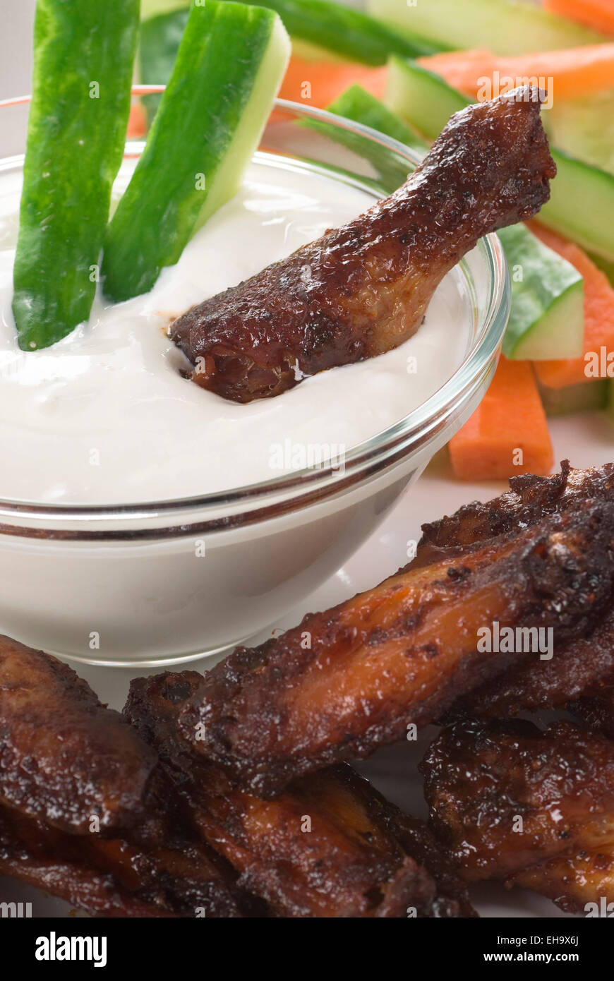 Würzige Hähnchenflügel mit Blauschimmelkäse Dip, Gurke und Karotte. Stockfoto