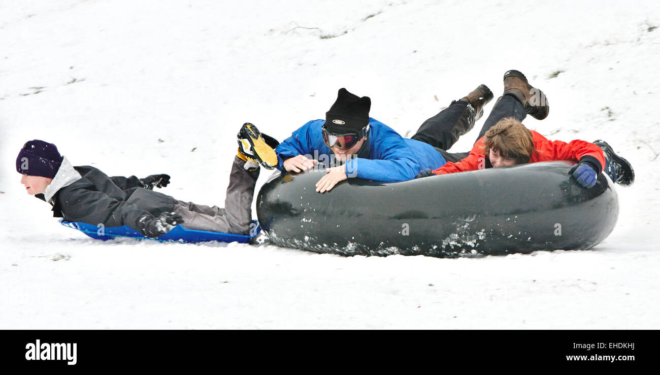 Kinder mit einem Reifen Schlauch als einen Schlitten nach einem Schneefall  in Ely Stockfotografie - Alamy