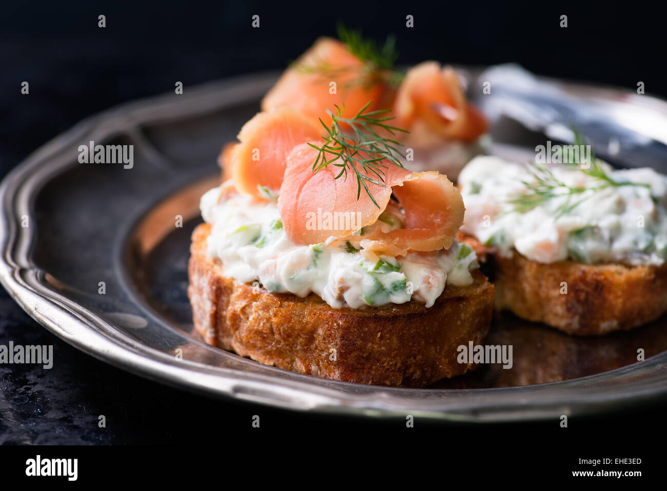 Kanapees mit geräuchertem Lachs und Frischkäse zu verbreiten, auf Vintage Metallplatte, selektiven Fokus Stockfoto