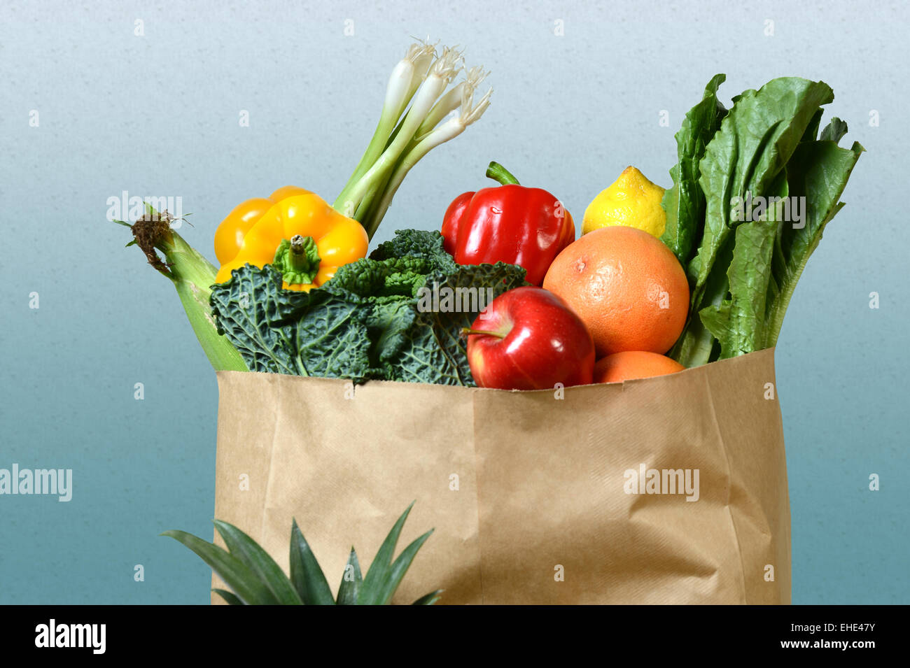 Auswahl an frischen Produkten in Papier-Einkaufstüte über gradient Hintergrund Stockfoto