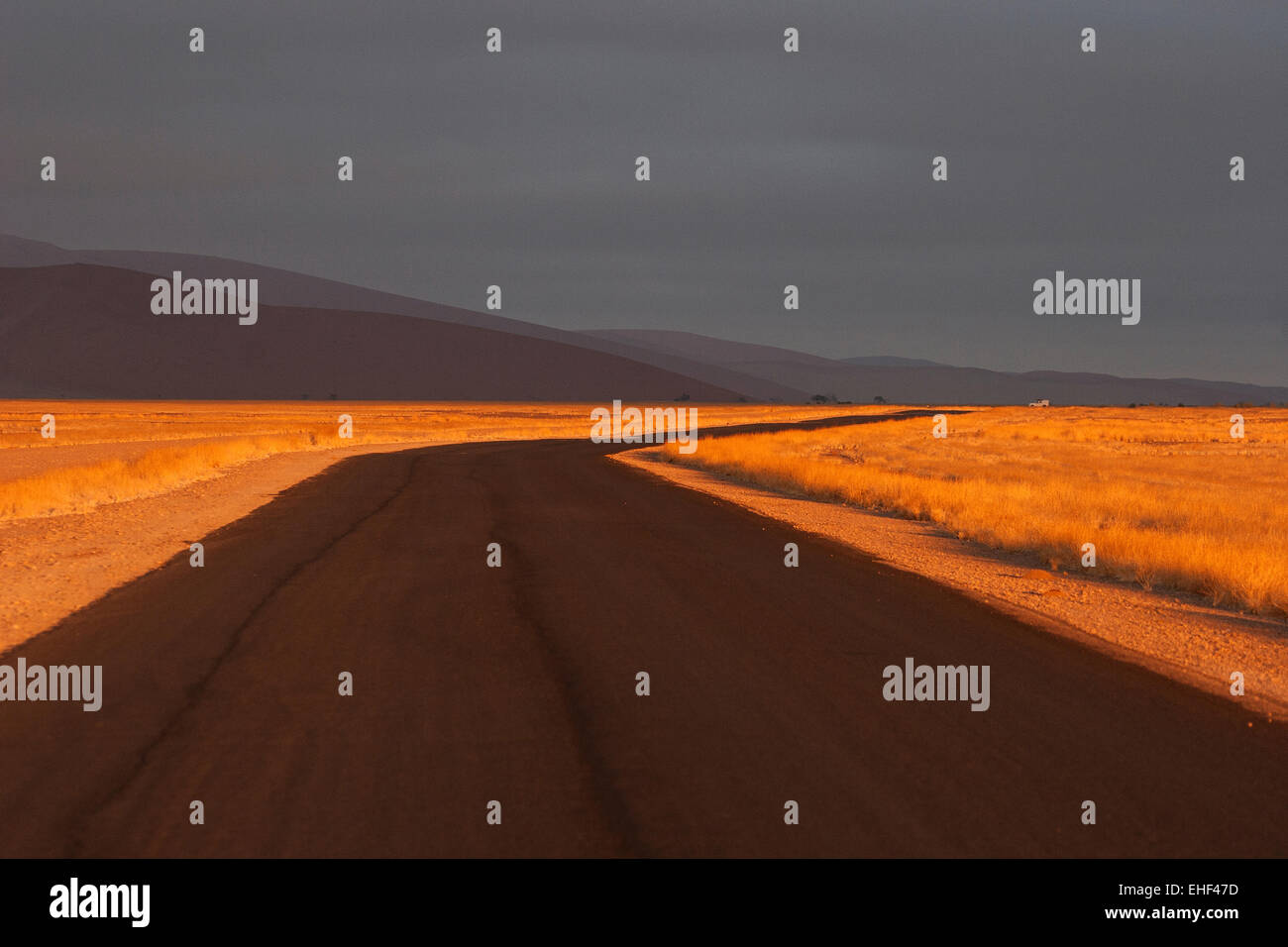 Straße nach Sossusvlei in den frühen Morgen Licht, dunkle Wolken, Sossusvlei, Namib Wüste, Namib-Naukluft-Nationalpark, Namibia Stockfoto