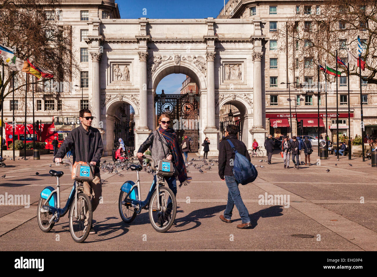 Marble Arch, London, England. Touristen gehen mit gemieteten Zyklen. Stockfoto