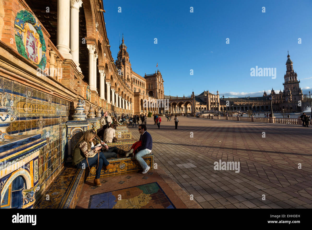 Menschen sitzen im Kachelofen Provinz Nischen an den Wänden von der Plaza de España, Spanien Platz, Luisa in Sevilla. Stockfoto