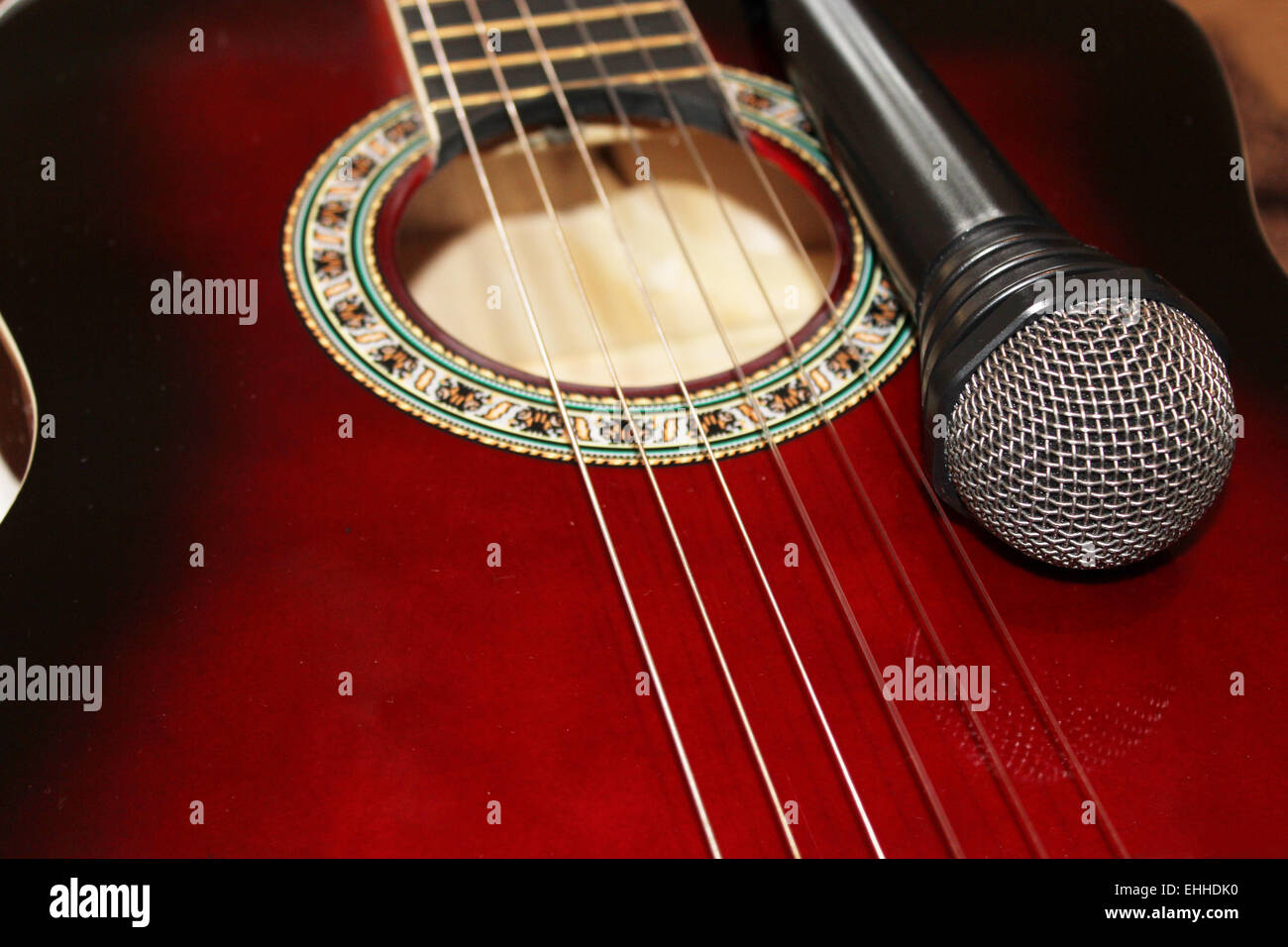 dunkle rote Gitarre und Fragment des Mikrofons Stockfoto dunkle rote Gitarre und Fragment des Mikrofons Stockfoto