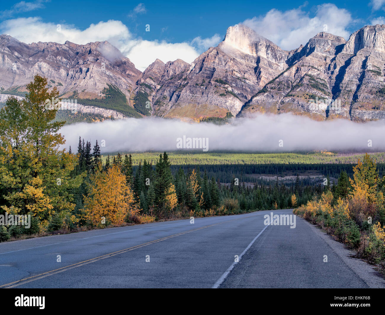 Straße, Nebel und niedrige Wolken mit Herbstfarben. Banff Nationalpark. Alberta, Kanada Stockfoto