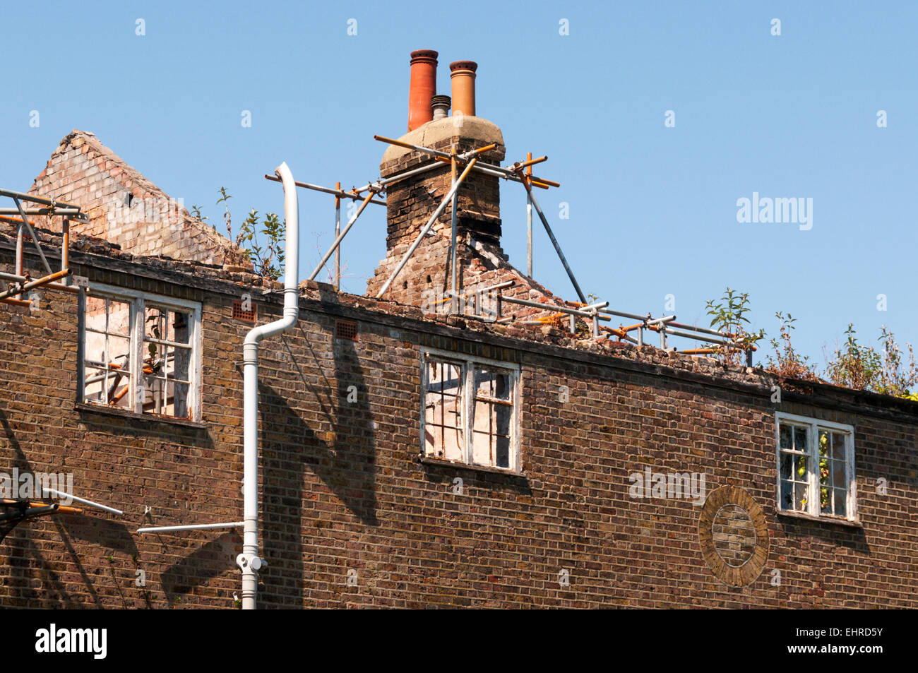 Dach aus alten Hütte mit Gerüst unterstützen Schornstein entfernt. Stockfoto