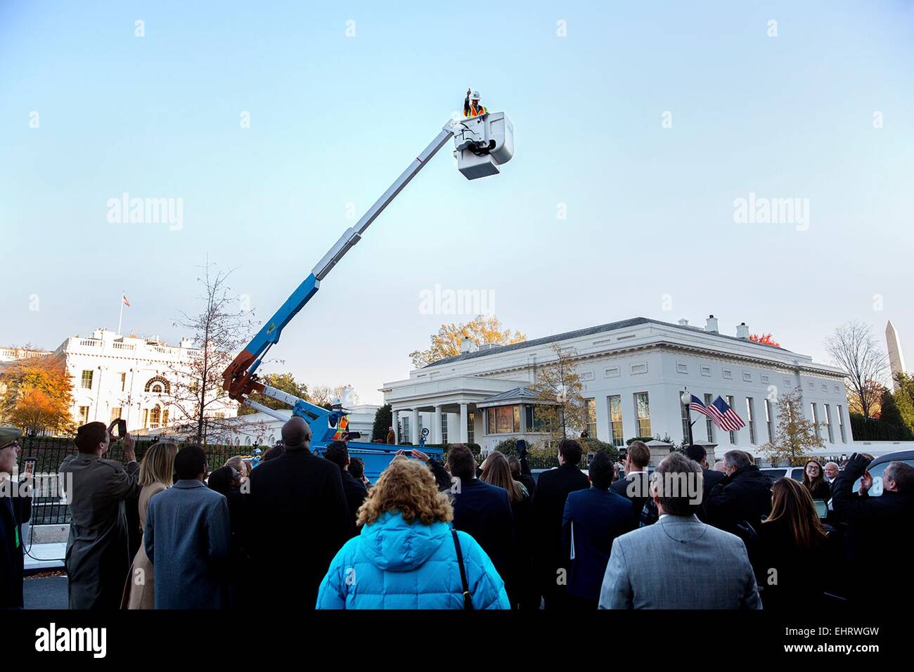 John Podesta, Berater des Präsidenten, gibt einen Daumen nach oben von hoch oben in einem Eimer LKW während einer Pacific Gas & elektrische Demonstration ihrer neuen Plug-in Hybrid Eimer LKW an der West Executive Avenue vor den Toren der Westflügel des weißen Hauses 18. November 2014 in Washington, DC. Stockfoto