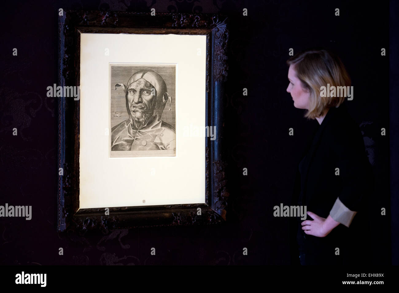 Kunstgeschichte-Studentin Carolin Bär untersucht der Kupferstich mit dem Titel "Kopf Eines Narren" (lit. ein Narrenkopf) des Künstlers Philips Galle um 1500 in der Ausstellung "Hieronymus Bosch Hiertage" in Dresden, Deutschland, 18. März 2015. Die Ausstellung läuft vom 19 März, 15. Juni 2015. Foto: Arno Burgi/dpa Stockfoto