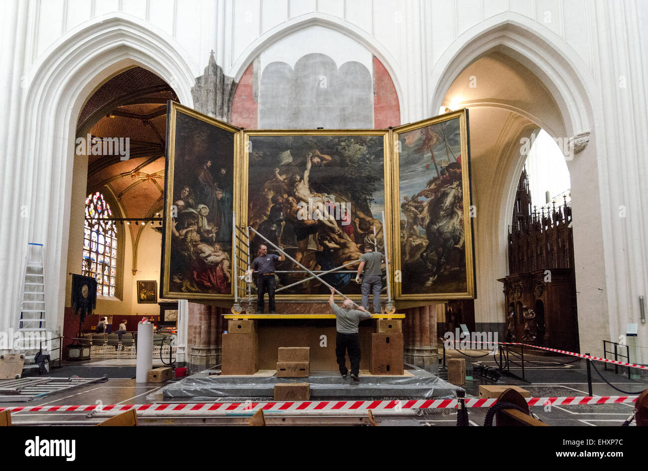 Arbeiter nachspielen versehentlich dem berühmten Gemälde der Peter Paul Reubens hinter Ihnen - die Erhöhung des Kreuzes mit Gerüst. Stockfoto