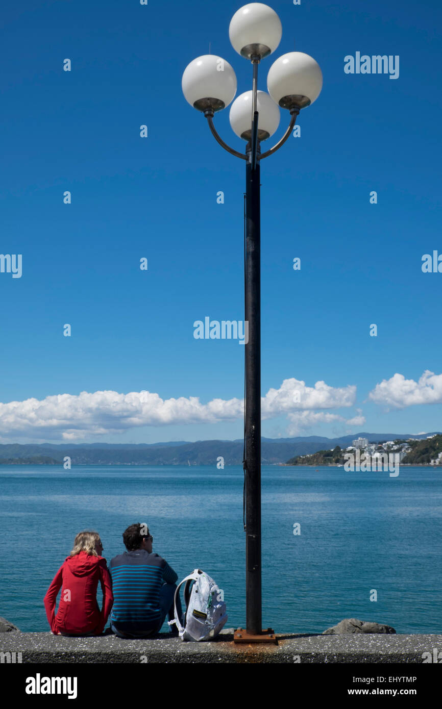 Leute sitzen am Wasser, Lambton Harbour, Wellington, Nordinsel, Neuseeland Stockfoto