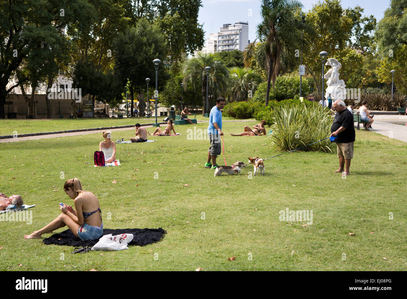 Argentinien, Buenos Aires, Almagro, Parque Centenario, Centenary Park, Menschen auf dem Rasen Sonnen Stockfoto