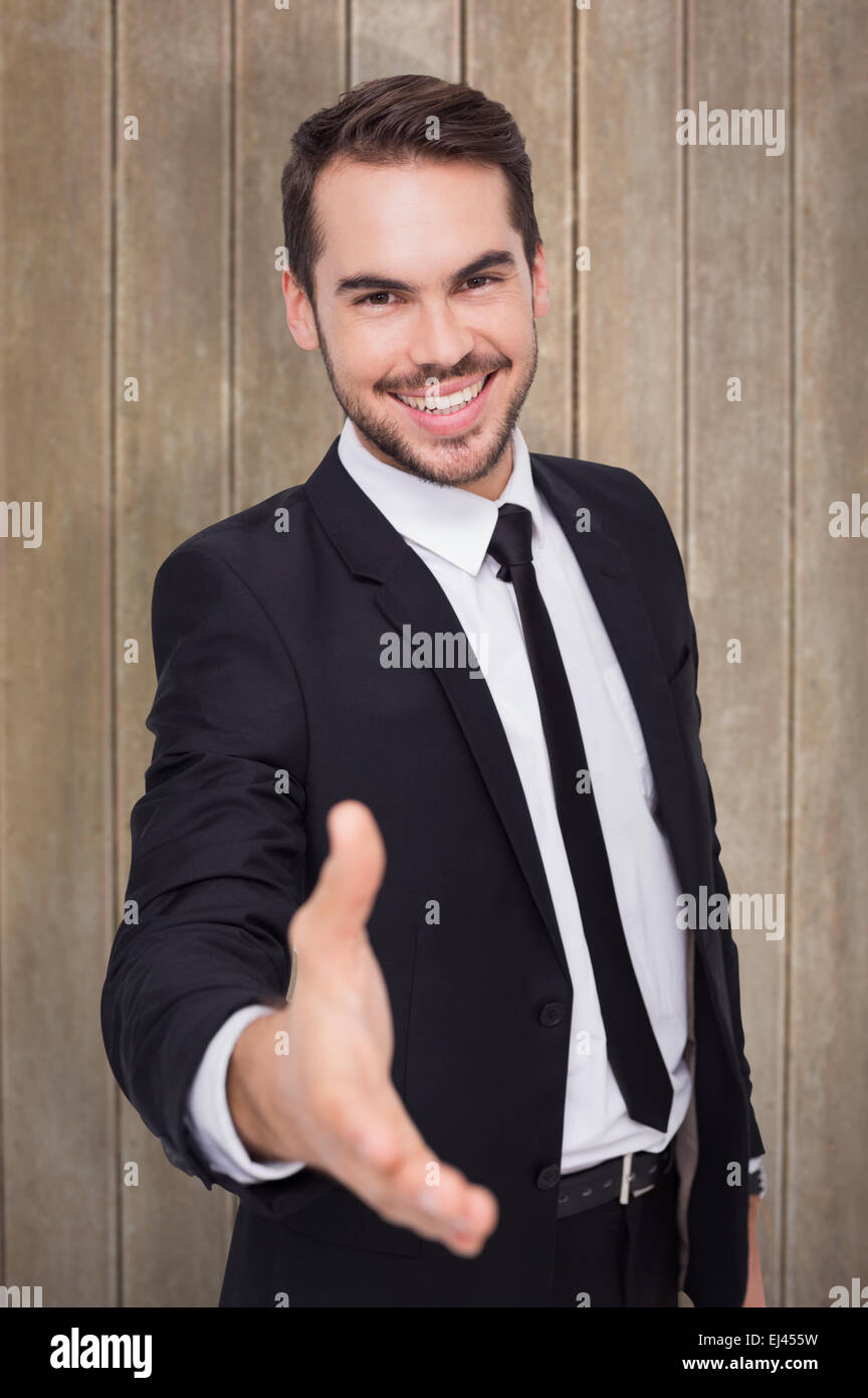 Zusammengesetztes Bild des Porträts von lächelnden Geschäftsmann bietet handshake Stockfoto