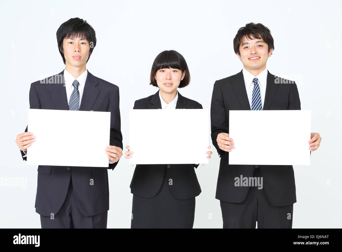 Junge Japanische Geschaftsleute Halten Weisse Tafeln Stockfoto
