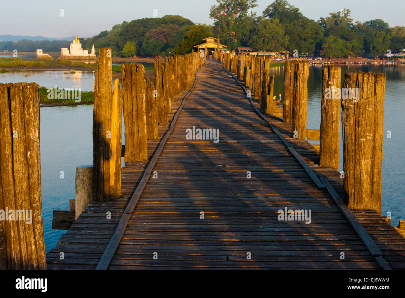 Teakholz U Bein Brücke mit Zitadelle Pagode in der Ferne auf Taungthaman-See bei Sonnenaufgang, Amarapura, Mandalay, Myanmar Stockfoto