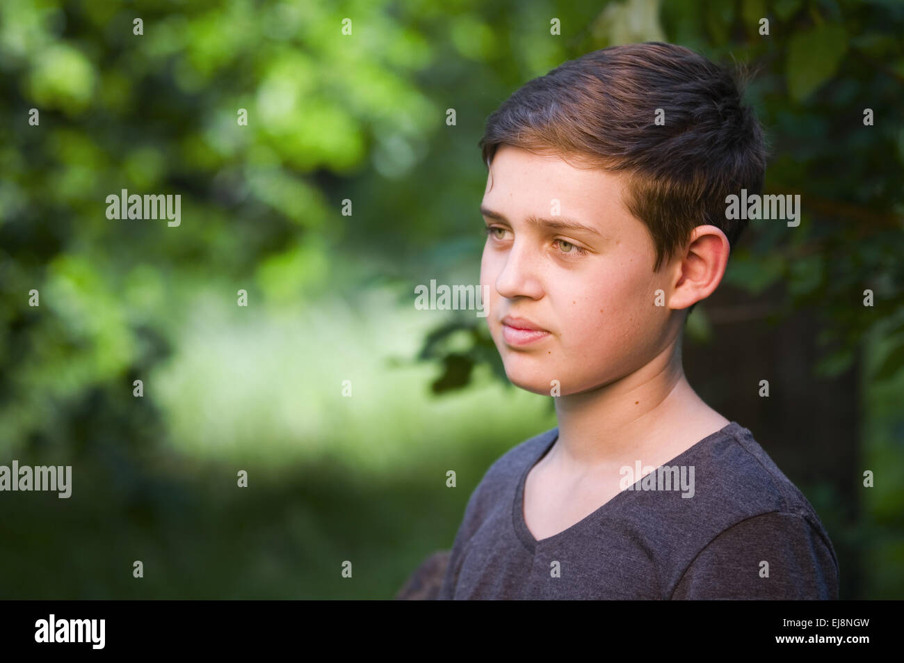 Boy-Look auf der Seite im Wald Stockfoto