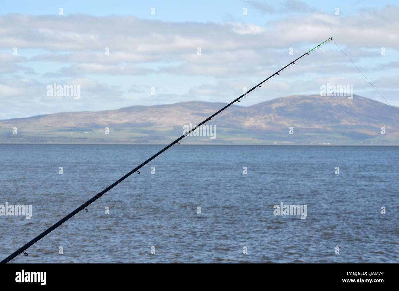 Angelrute am Pier in Silloth, The Solway Firth. Auf der anderen Seite sind die Hügel des südlichen Galloway Stockfoto