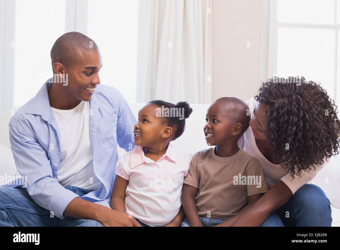 Glückliche Familie zusammen auf der Couch sitzen Stockfoto