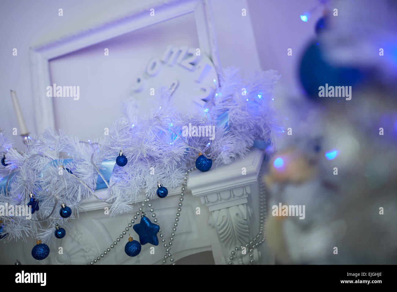 Weihnachtsbaum, Kamin, Uhren, Spielzeug, Geschenke in einem weißen Raum Stockfoto