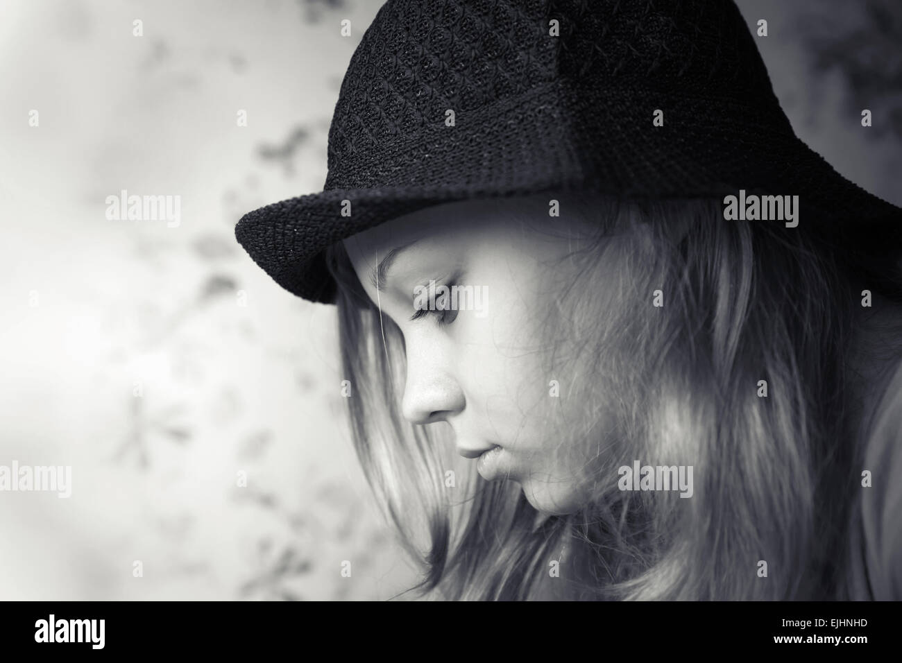 Monochrome Closeup Profilbildnis schöne blonde Teenager-Mädchen in schwarzen Hut Stockfoto