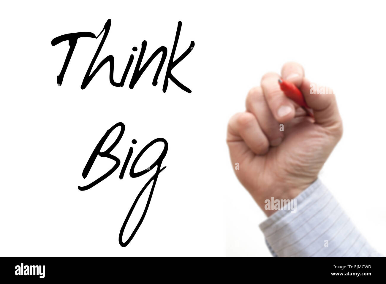 Ein Foto / Illustration einer unscharf Hand, die nur schrieb "Think Big" Stockfoto