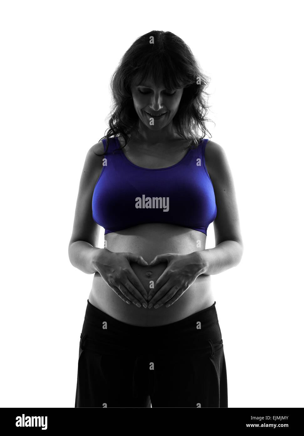 eine schwangere Frau bilden Herzform auf Bauch Silhouette auf weißem Hintergrund Stockfoto