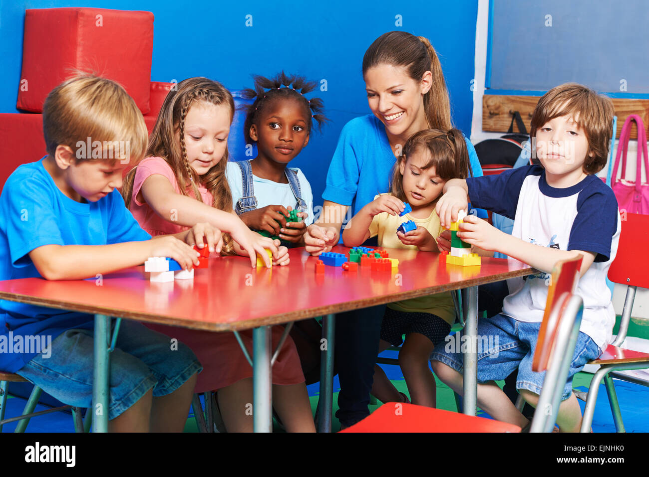 Kinder und Kindergarten Lehrer spielen mit Bausteinen in einem Kindergarten Stockfoto