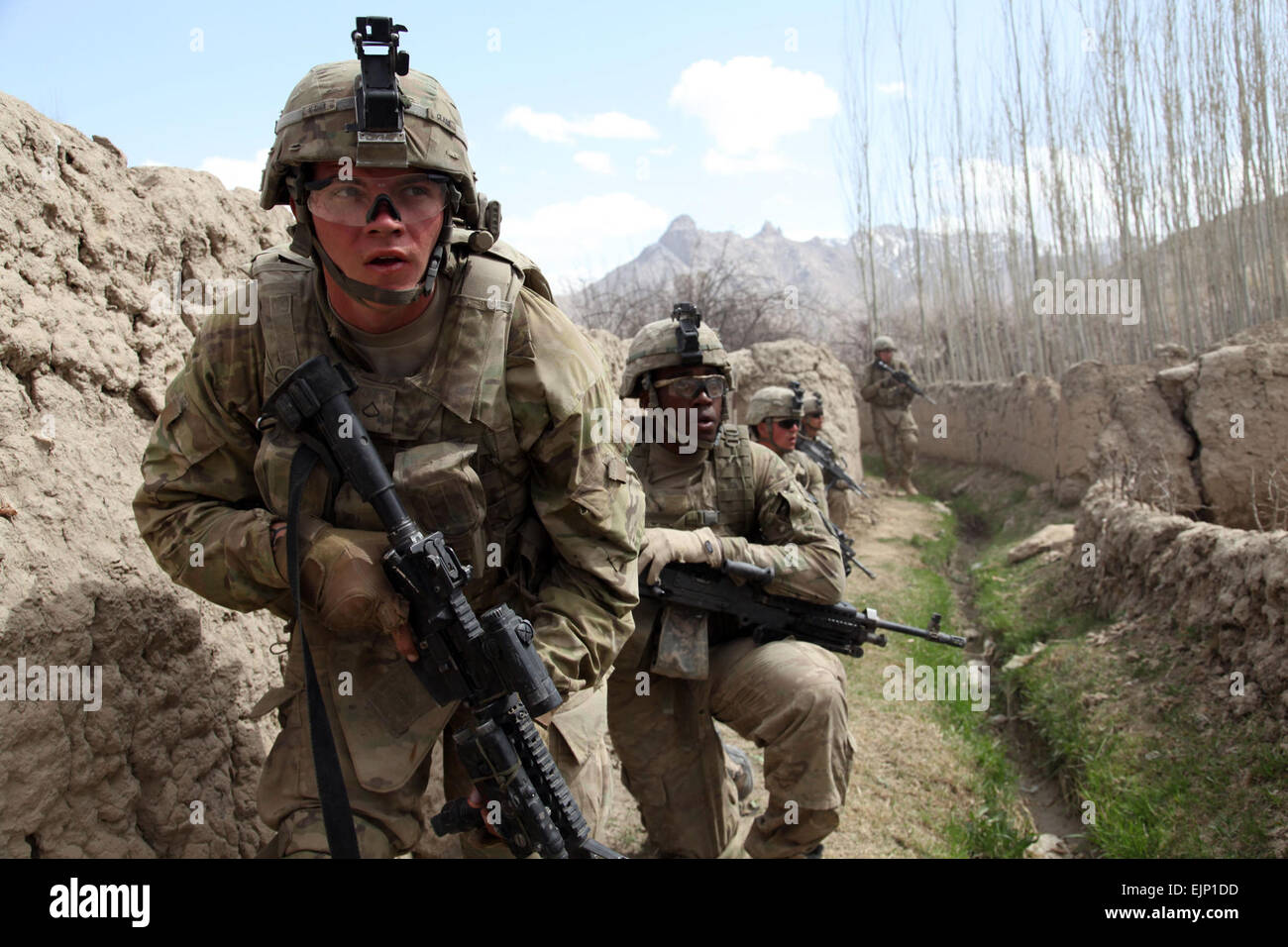 US Army Pfc. Joshua Clark und Spc. Saikan Corbitt mit 4th Brigade Combat Team, 10th Mountain Division, 30. Infanterie-Regiment, 2. Bataillon, 1. Zug, Bravo Kompanie bewegen hinter Lehmwänden, um einen feindlichen Scharfschützen während Betrieb Charkh Restaurierung, Charkh District, Provinz Logar, Afghanistan, April 5 übernehmen. Stockfoto